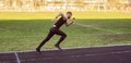 One caucasian male is doing a sprint start. running on the stadium on a rubber track. Track and field runner in sport uniform. Royalty Free Stock Photo