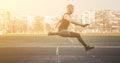 One caucasian male in a jump over a barrier. running on the stadium. Track and field runner in sport uniform in flight. energetic Royalty Free Stock Photo