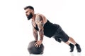 One caucasian man exercising fitness weights Medicine Ball push ups exercises in studio isolated on white background Royalty Free Stock Photo