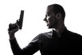 One caucasian man holding gun portrait silhouette Royalty Free Stock Photo