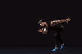 One caucasian man young sprinter runner running in silhouette studio on dark background.