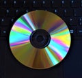 Single CD or DVD on keyboard closeup detail Royalty Free Stock Photo