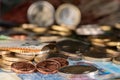 One cent copper coins and 2 euro coin in focus and different euros out of focus. Money for rent or purchasing goods Royalty Free Stock Photo
