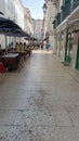 One of the central streets of Lisbon with cafes and walking tourists