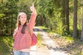 One cheerful traveler teen girl, showing thumb up.teenager hand gesturing thumbs up in a park.Summer sunny day