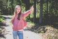 One cheerful traveler teen girl, showing thumb up.teenager hand gesturing thumbs up in a park.Summer sunny day