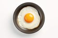 One Chicken Egg in a Small Pan Isolated, Lightly Fried Egg on White Background Top View, Flat Lay Royalty Free Stock Photo