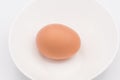 One chicken egg in a white bowl Royalty Free Stock Photo