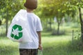 One child walks with garbage bags