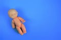 one childrens toy doll for children from one year on a blue background with a place for the inscription. close up