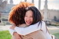 One chinese young woman embracing her friend. A couple giving each other a tender hug. Emotive farewell or welcome Royalty Free Stock Photo
