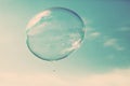 One clean soap bubble flying in the air, blue sky. Vintage Royalty Free Stock Photo