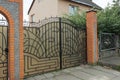 One closed gray metal gate with a black wrought iron pattern Royalty Free Stock Photo