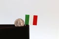 One coin of Italy Lire money and mini Italy flag stick on the black wallet with white background. REPVBBLICA ITALIANA, Lire Italia