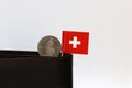 One coin of one swiss Franc and mini Switzerland flag stick on the black wallet with white background. Franc Schweiz money Royalty Free Stock Photo