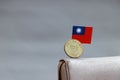 One coin of Taiwan fifty dollars money on obverse, portrait of Dr.Sun Yat-Sen, first president and mini Taiwan flag stick on the