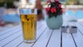 One cold alcoholic beer in transparent glass on sunny day by pool Royalty Free Stock Photo