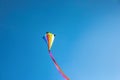 One colorful kite flying in sky on sunny day Royalty Free Stock Photo