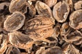 One complete walnut with cracked walnut shells. Pieces of nutshells. Royalty Free Stock Photo