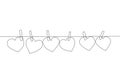 One continuous line drawing of cute heart shape paper hanged on the rope with clothesline. Romantic marriage greeting card concept Royalty Free Stock Photo