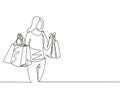 One continuous line drawing young happy beauty woman holding paper bags after buying dress, make up, cosmetic, fashion in mall.