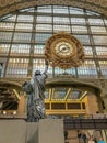 Statue of Liberty copy reaches up toward gilded clock in the Musee d`Orsay, Paris, France