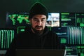 One criminal hacker man programming a phishing virus, at background a lot of data screens. One caucasian developer Royalty Free Stock Photo