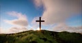 One cross on the hill with clouds moving on blue starry sky