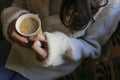 One cup cappuccino with woman hand