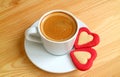 One Cup of Espresso Coffee with a Pair of Red Heart Shaped Cookies on Wooden Table Royalty Free Stock Photo