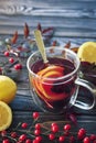 One cup of hot berry tea in autumn leaves decoration, winter autumn mood, citrus red tea, autumn concept Royalty Free Stock Photo