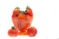One cup of strawberry`s with two strawberry`s standing Royalty Free Stock Photo