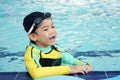 Little asian boy learn swimming in pool in activities time Royalty Free Stock Photo