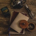 One Dark Brown and Two Gray Journals Lying in a Fanned Fashion on Top of a Wooden Textured Background