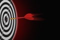 one dart hit it's target on a red background, concept for success Royalty Free Stock Photo