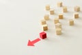 One different red cube block among wooden blocks. Individuality, leadership and uniqueness concept. Royalty Free Stock Photo