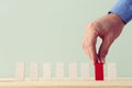 One different red cube block among wooden blocks. Individuality, leadership and uniqueness concept Royalty Free Stock Photo