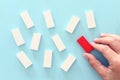 One different red cube block among wooden blocks. Individuality, leadership and uniqueness concept Royalty Free Stock Photo