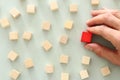 One different red cube block among wooden blocks. Individuality, leadership and uniqueness concept. Royalty Free Stock Photo