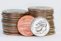 One dime and cent against stack of American quarter coins. Royalty Free Stock Photo