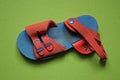 One dirty blue sandal with red leather harnesses Royalty Free Stock Photo