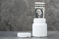 One dollar banknote rolled in the pharmaceutical bottle Royalty Free Stock Photo