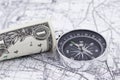 One-dollar bill, compass and map