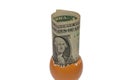 A one dollar in an egg shell on white background Royalty Free Stock Photo
