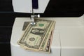 one dollar lies on a sewing machine, money production, finance, income