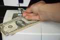 one dollar lies on a sewing machine, money production, finance, income