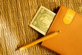 One dollar in a notebook with pen on wooden bamboo background. money as a bookmark