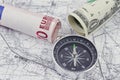One-dollar, ten Euro bills and a compass Royalty Free Stock Photo