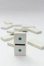 One domino still standing on white background Royalty Free Stock Photo