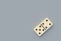 One domino tile on gray background Royalty Free Stock Photo